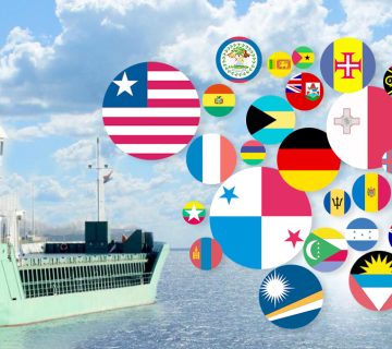 Cargo ship flying a national flag during international voyage – ship registration and flag state concept.